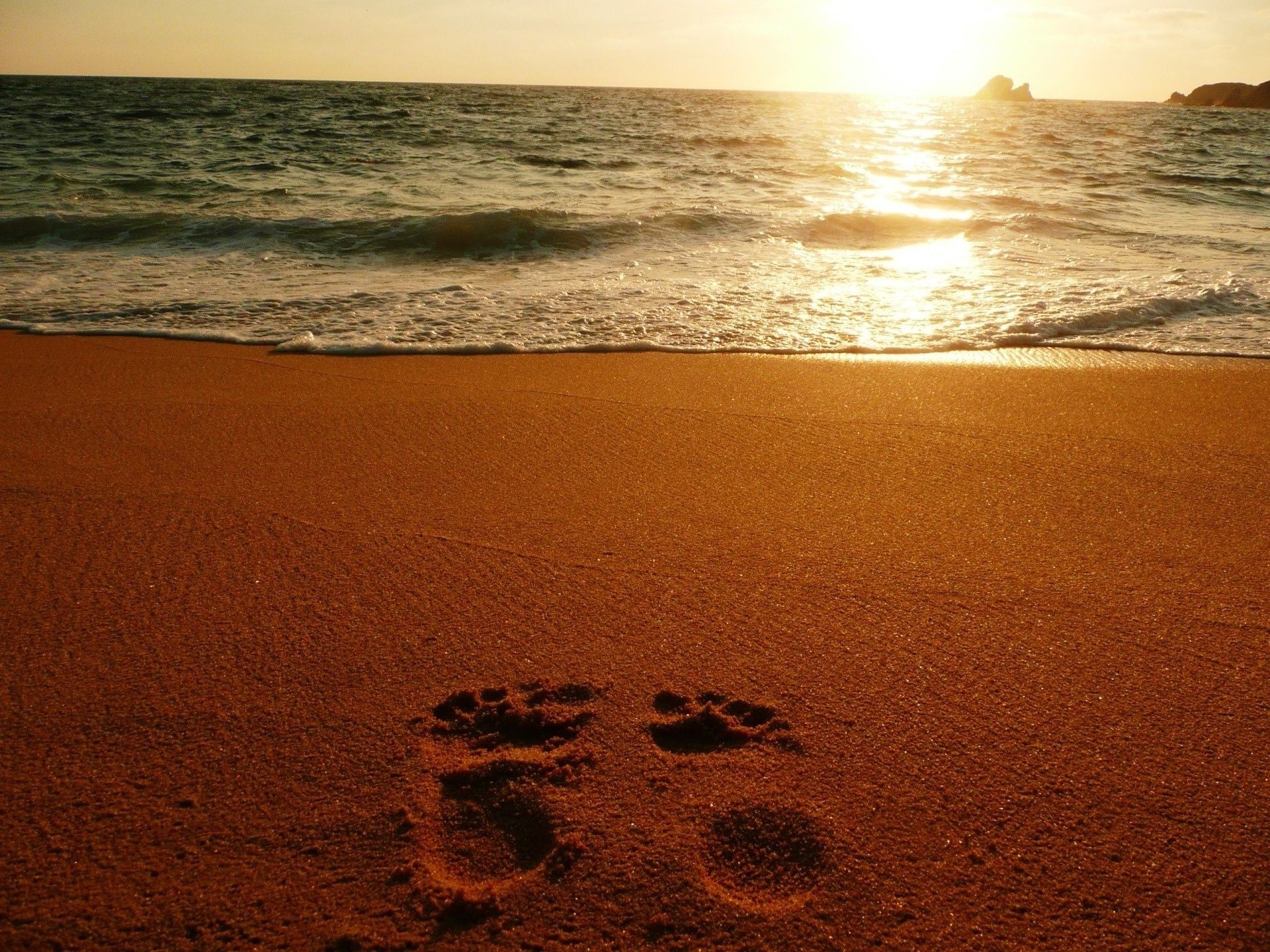 the sunset and sunrise beach sand sunset seashore sea water ocean surf sun seascape dawn evening landscape fair weather dusk wave travel footprint tide