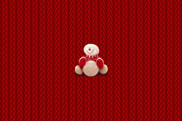 Plush snowman on a red wicker background