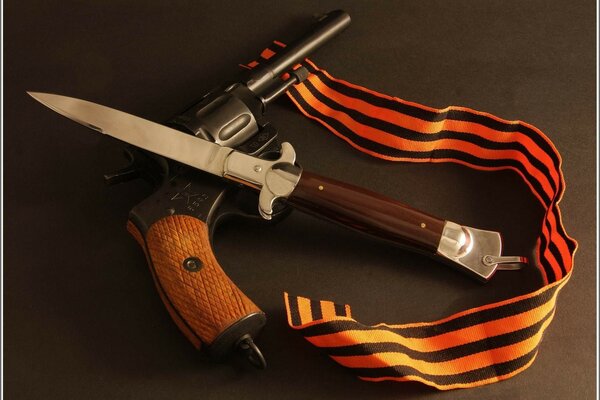 Knife, revolver and St. George ribbon on the table