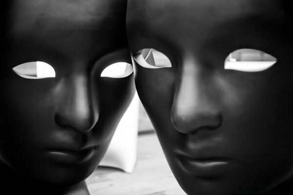 Face masks of men and women black and white photo