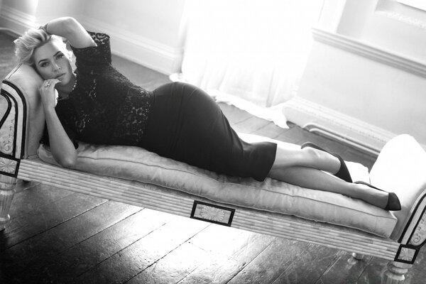 The lady lies languidly on the sofa