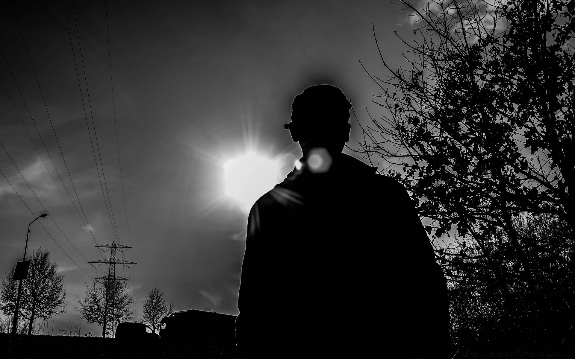 black and white silhouette monochrome man sunset light sun dark shadow sky backlit portrait
