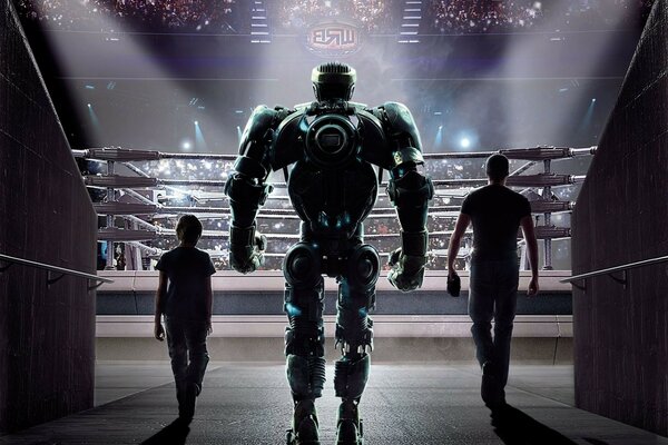 A robot enters the ring accompanied by two people