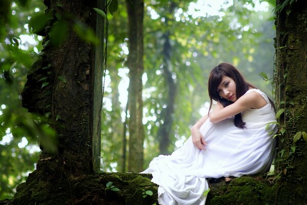 A girl in a white shirt in the forest