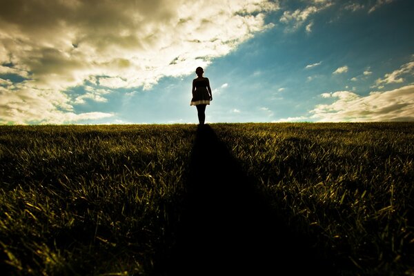 Girl in a dress against the sky