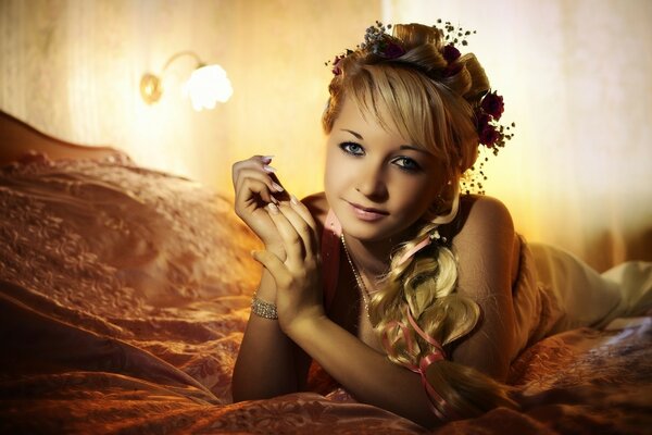 Portrait of a beautiful girl lying on a bed