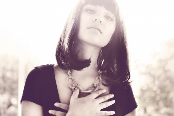 The girl holds her hands on her chest