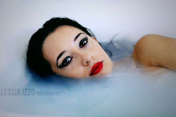 Girl in the bath with bright makeup