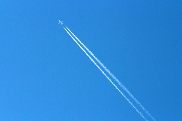 The trace of the plane in the blue sky