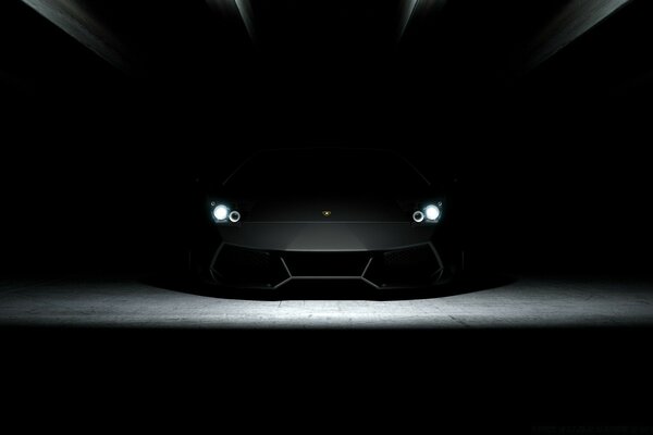 A black car in a dark room