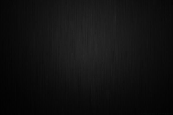 A pale barely visible light spot on a black background