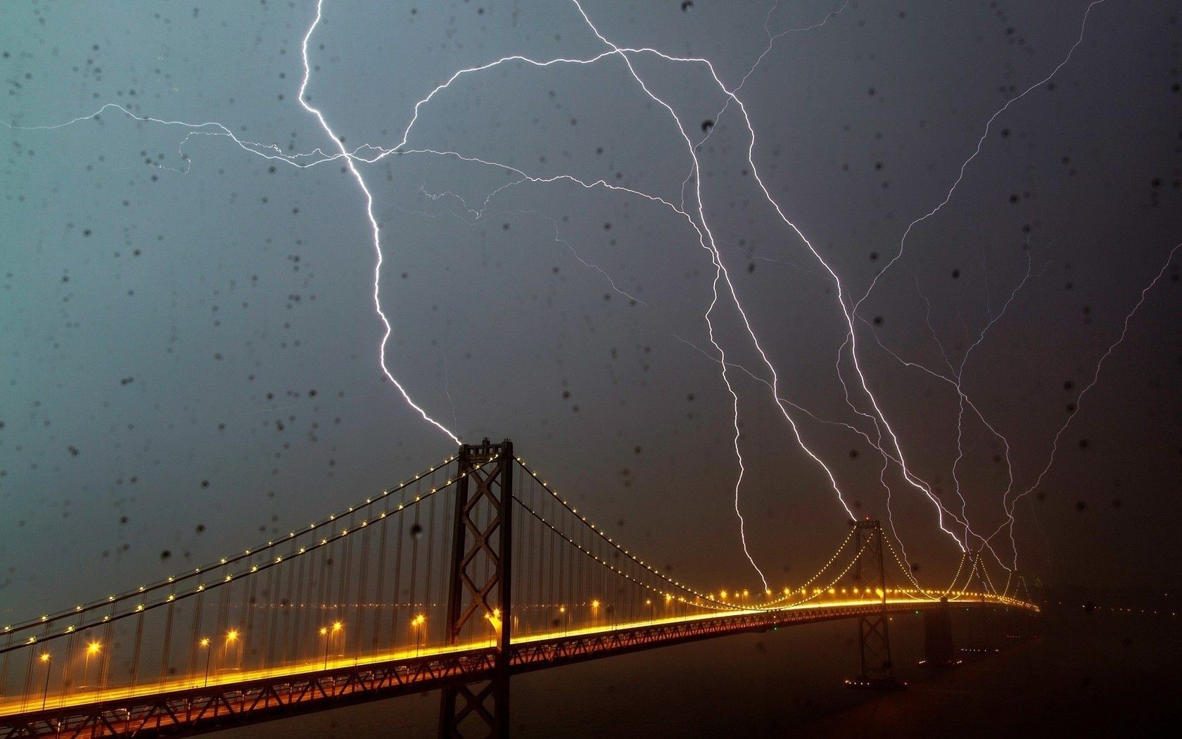 lightning bridge storm evening light dark sky transportation system thunder rain travel city highway thunderstorm water road calamity connection vehicle