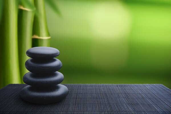 Stones on a mat on a bamboo background