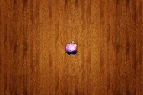 A small colored Apple icon on a wooden background