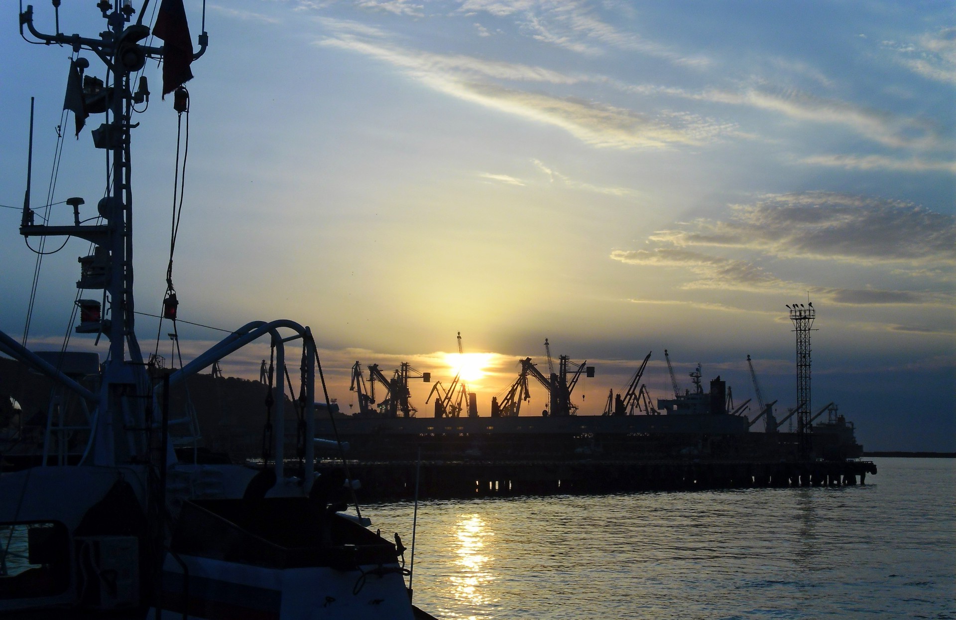the sunset and sunrise watercraft water sunset sea pier ship industry boat harbor ocean transportation system dawn sky energy port silhouette evening vehicle