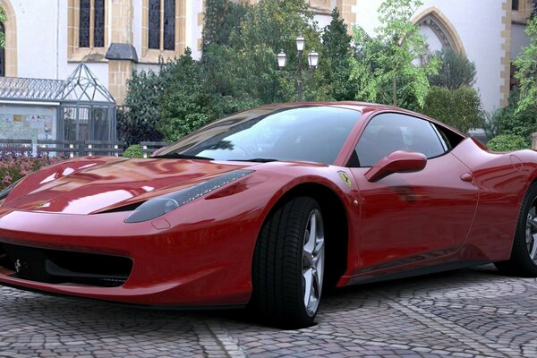The red sports car is parked in the yard
