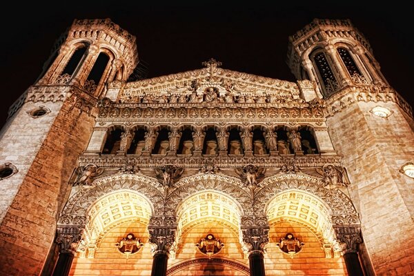 The ancient building is illuminated by lanterns