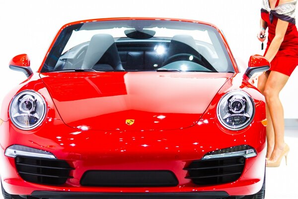 Red Porsche convertible with round headlights