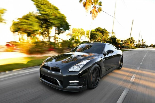 Fast black car on asphalt