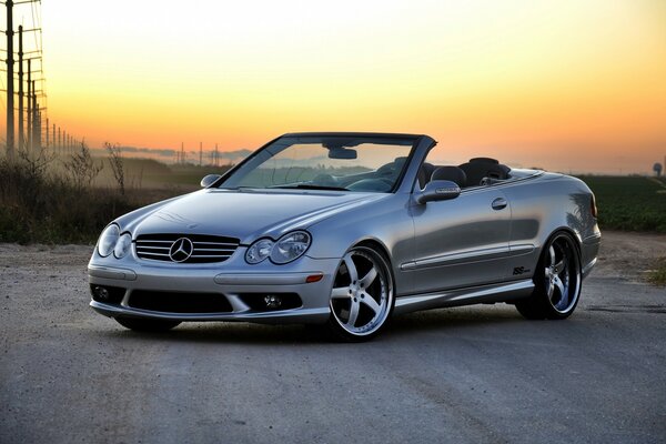 Mercedes stopped in the background of sunset