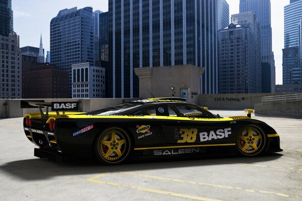 A black and yellow racing car with the number 38