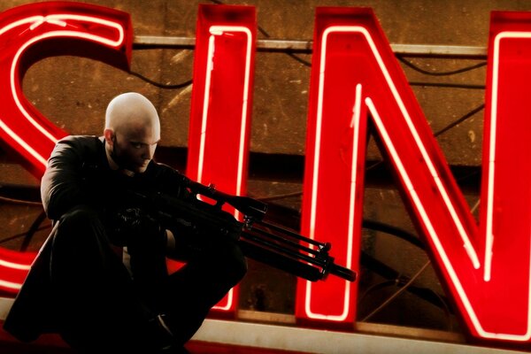 Hitman is looking for a target on the background of the inscription