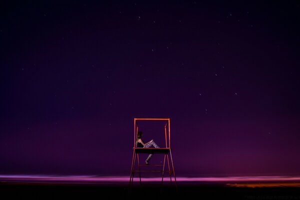 A lonely swing set against the night sky