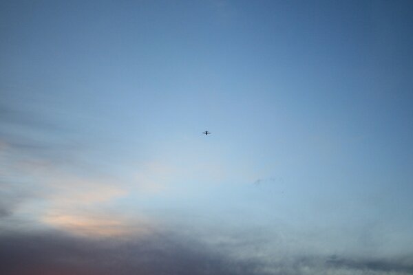 A plane flying in a cloudy sky