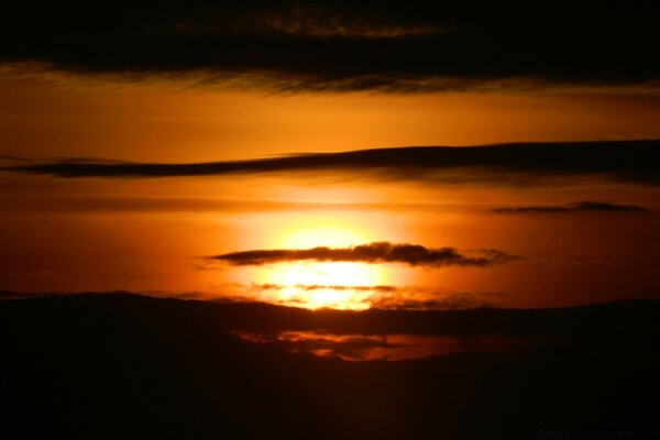 Clouds on the background of the setting sun