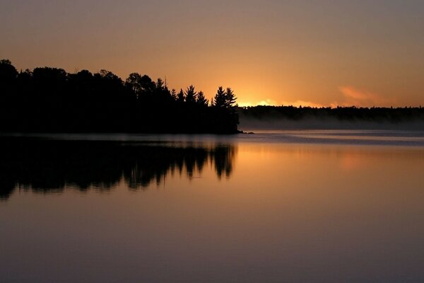 Evening sunset and sunrise over the waters of the lake
