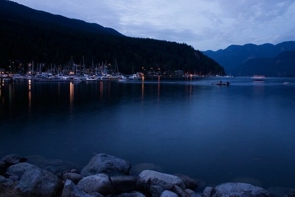 The lights are reflected in the dark water