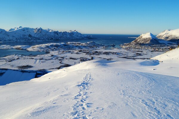 Snow-covered road leading to the lake