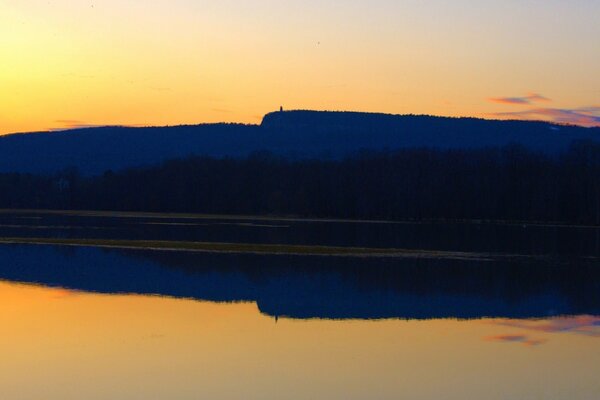 View from the shore of the violet - orange sunset