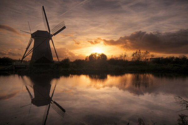 Chickenpox on the lake on the background of sunset